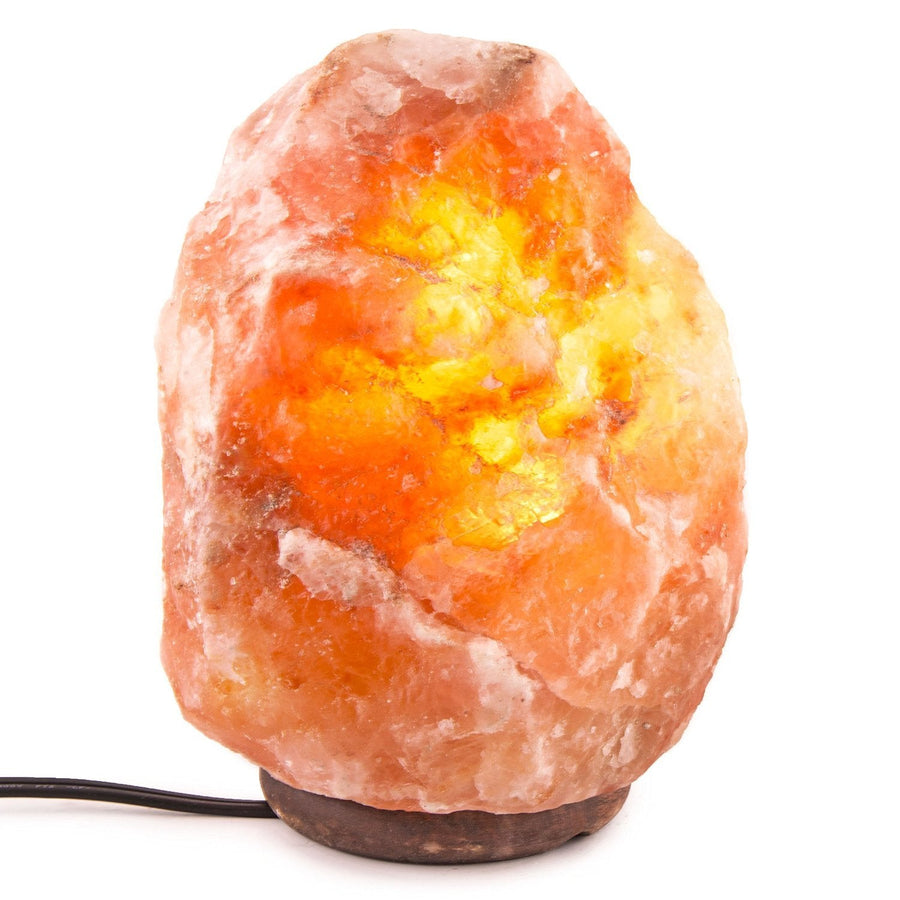 Himalayan salt lamp with a warm glow on a white background